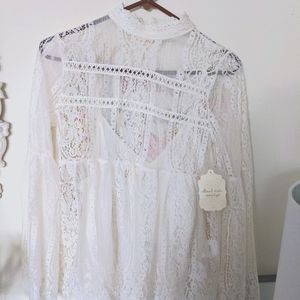 White lace blouse with flared arms